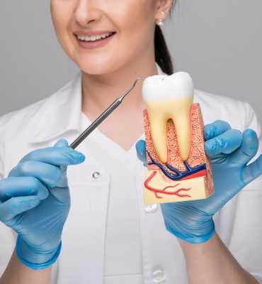 closeup-picture-woman-doctor-holding-tooth-with-caries-tool