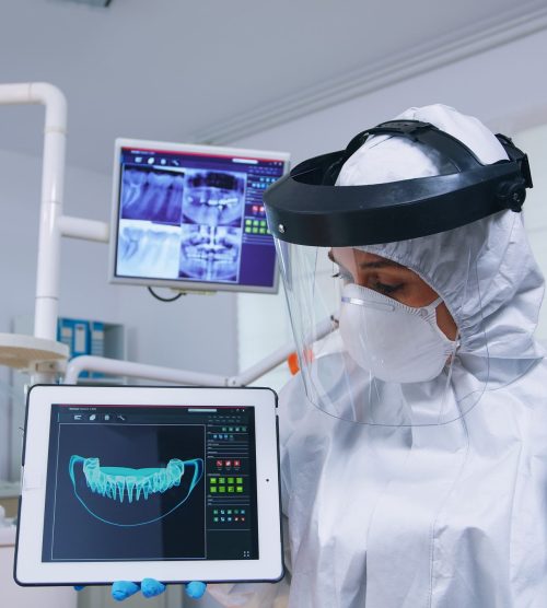 patient-pov-listening-explication-teeth-treatment-dentist-coverall-showing-x-ray-tablet-stomatology-specialist-wearing-protective-suit-against-infection-with-covid19-pointing-radiograph (3)