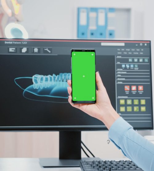 woman-working-as-dentist-with-green-screen-smartphone-oral-care-office-dentist-holding-mobile-phone-with-mockup-template-isolated-background-teethcare-dentistry (1)